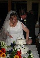 Cutting of the cake: part two. Notice the white knuckles